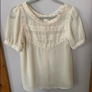 Cream colored sheer blouse